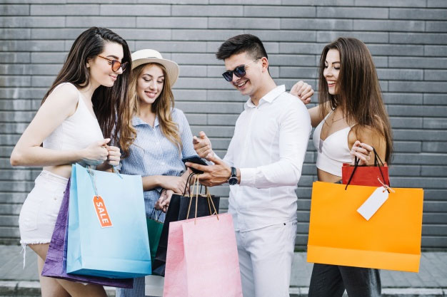 Group of shoppers with their smartphones